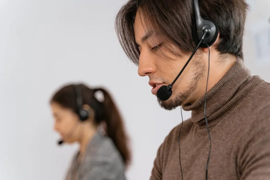 Call center employees wearing headsets assisting customers